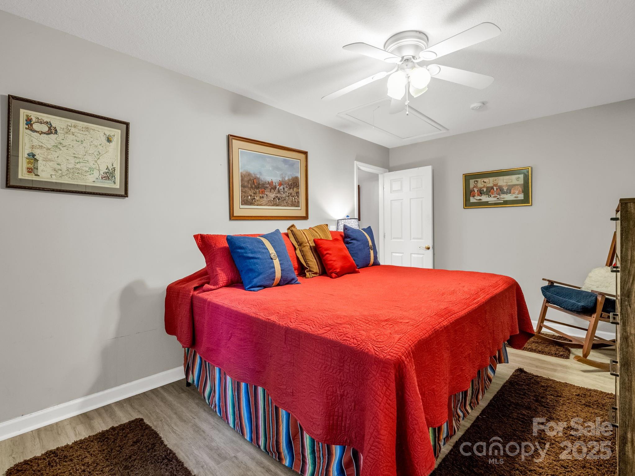 134 Downing Place Lake Lure, NC 28746 - Photo 21 of 35 a bedroom with bed and paintings on the wall