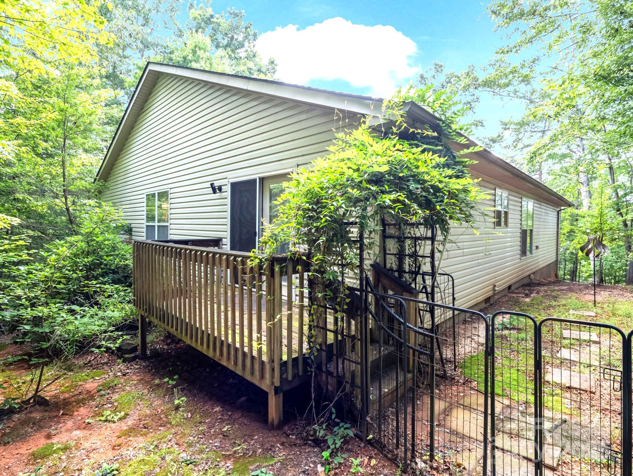 134 Downing Place Lake Lure, NC 28746 - Photo 26 of 35 a view of a house with a small yard and wooden fence