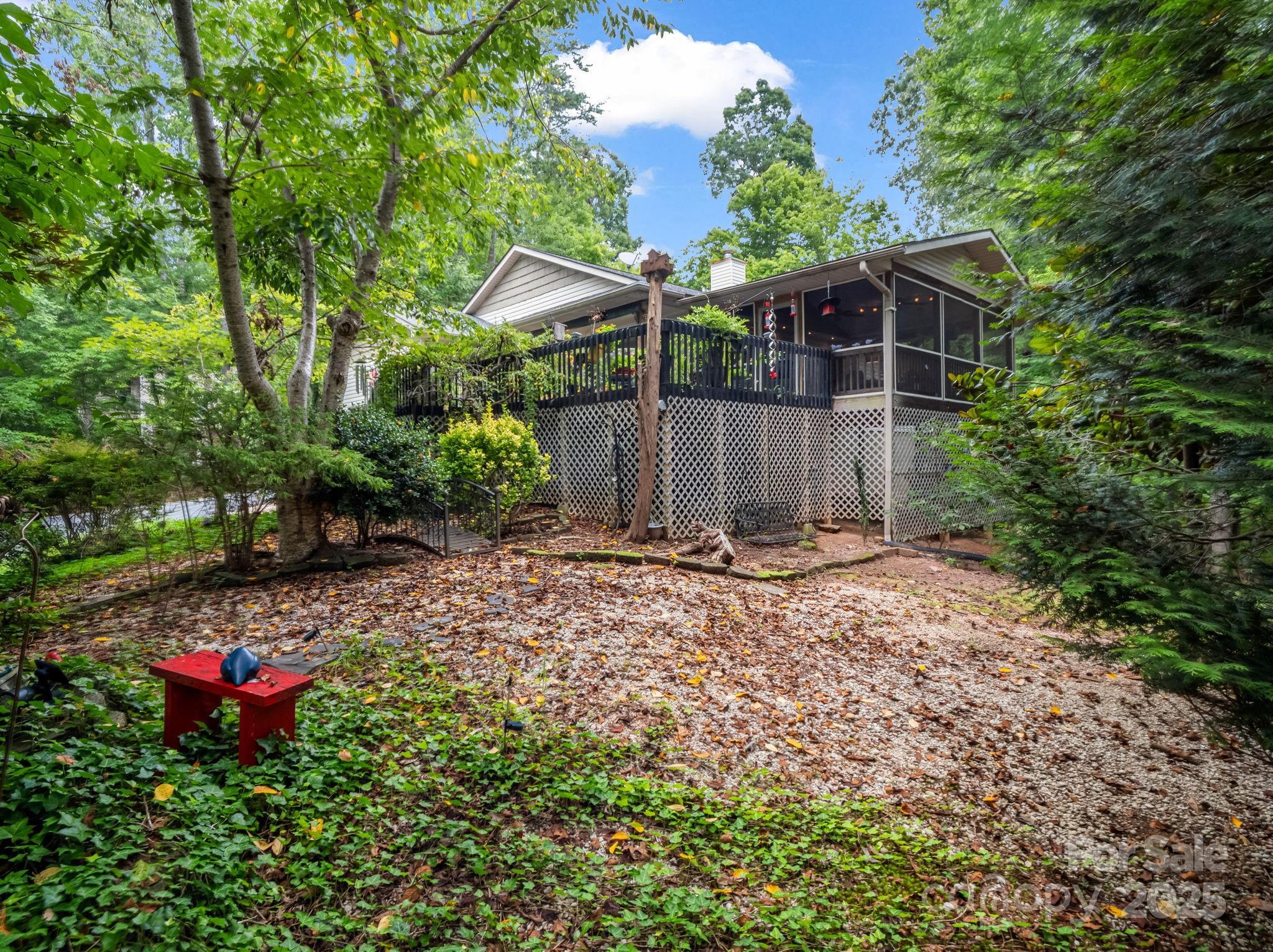 134 Downing Place Lake Lure, NC 28746 - Photo 32 of 35 a view of a house with a yard and a fence