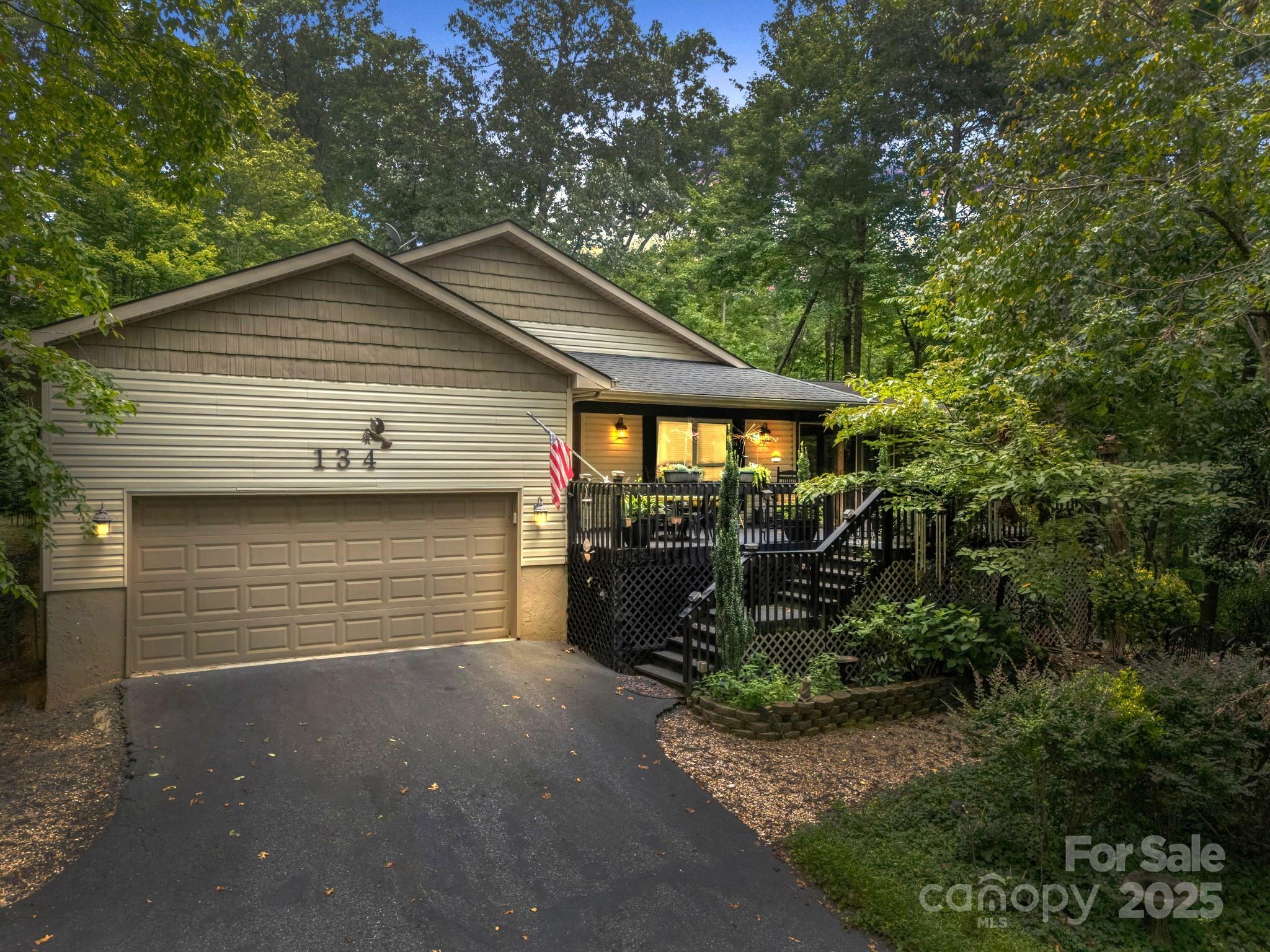 134 Downing Place Lake Lure, NC 28746 - Photo 34 of 35 a front view of a house with garden