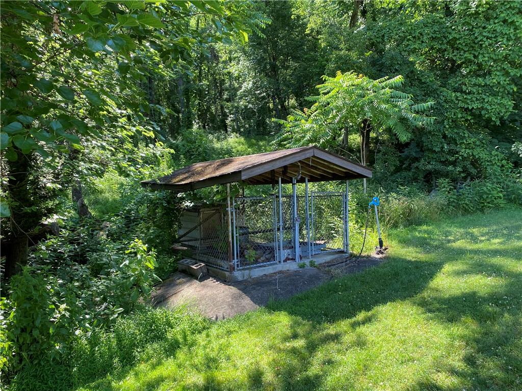 709 Indian Hill Road Rostraver Township, PA 15012 - Photo 11 of 25 a backyard of a house with table and chairs under an umbrella