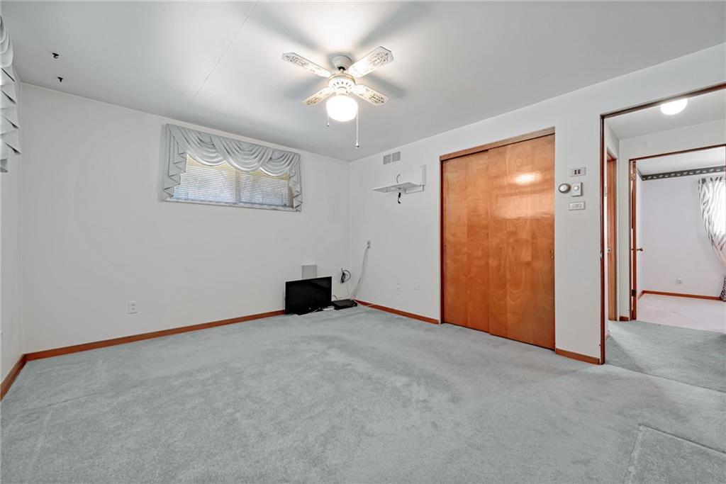 709 Indian Hill Road Rostraver Township, PA 15012 - Photo 24 of 25 an empty room with windows and fan