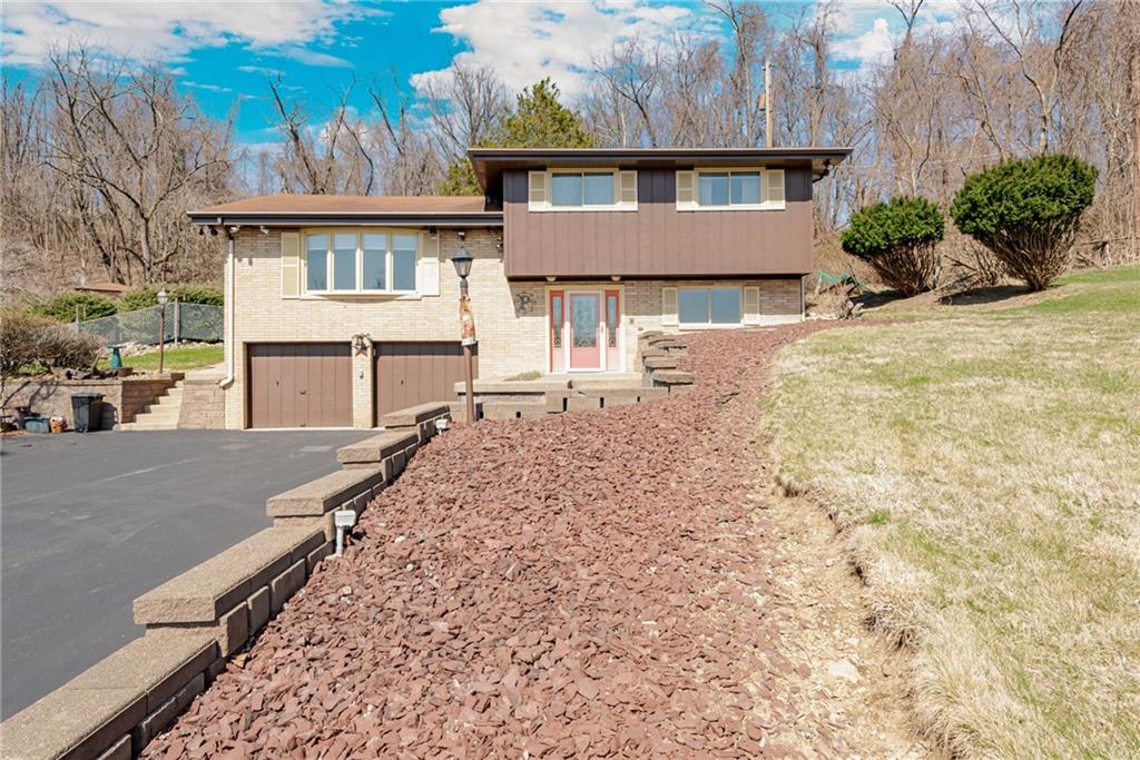 709 Indian Hill Road Rostraver Township, PA 15012 - Photo 3 of 25 a front view of a house with a yard