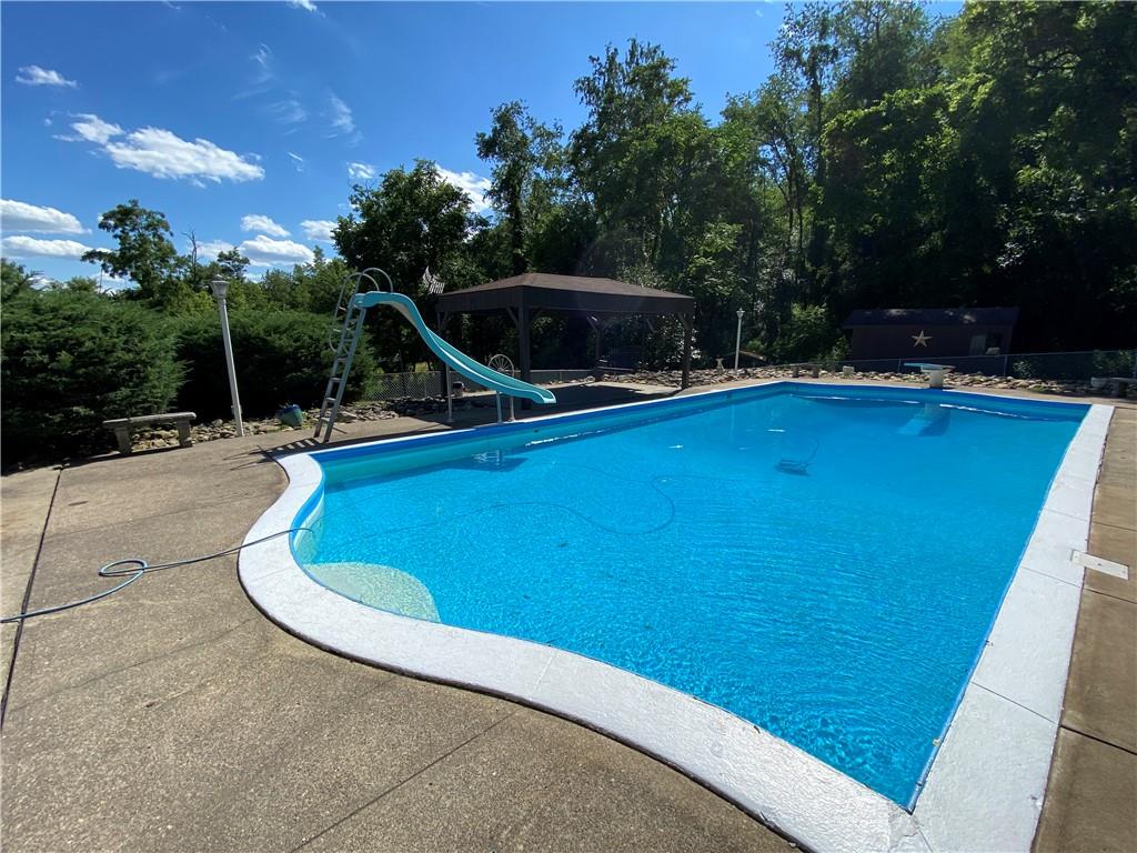 709 Indian Hill Road Rostraver Township, PA 15012 - Photo 6 of 25 a view of a swimming pool with an outdoor seating and a yard