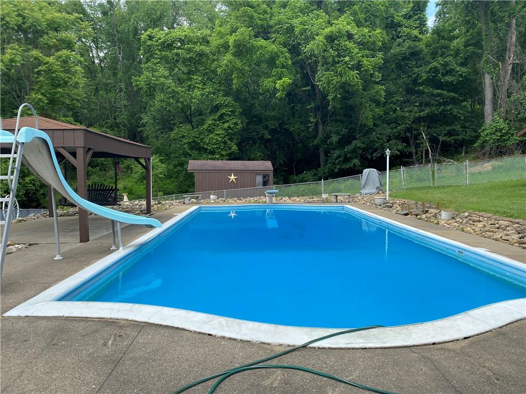 709 Indian Hill Road Rostraver Township, PA 15012 - Photo 7 of 25 a view of a swimming pool with a lounge chairs