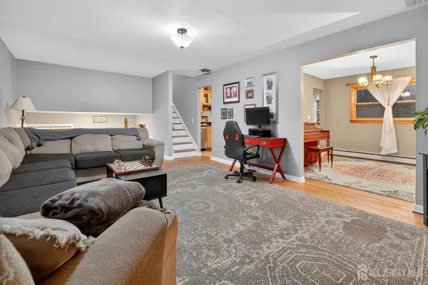 a living room with furniture a flat screen tv and a large window