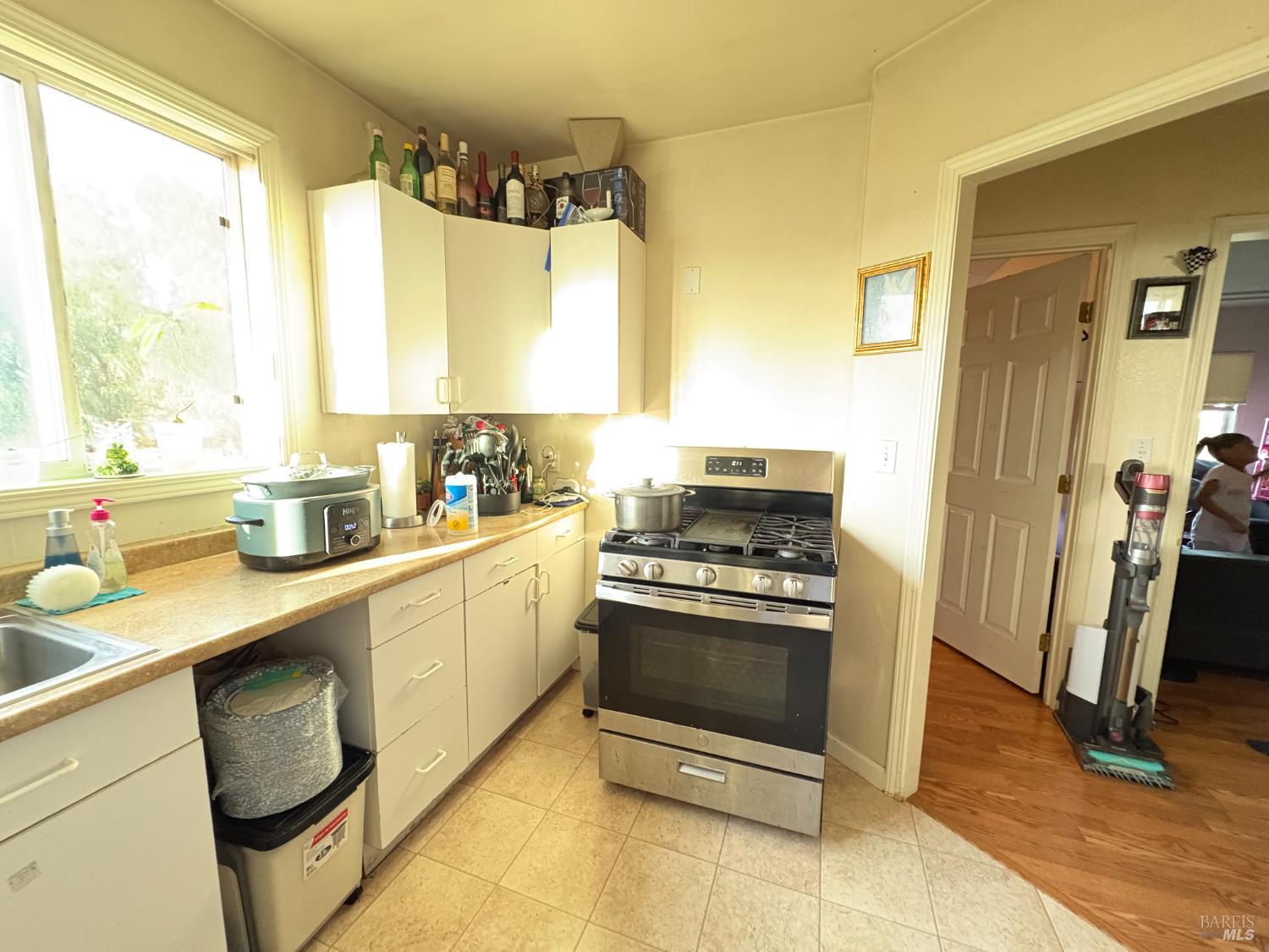 313 Roney Avenue Vallejo, CA 94590 - Photo 22 of 26 a kitchen with a sink stove and refrigerator