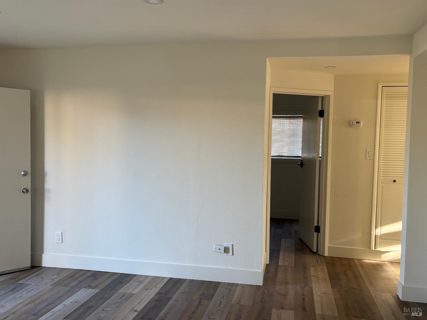 313 Roney Avenue Vallejo, CA 94590 - Photo 7 of 26 an empty room with wooden floor and closet