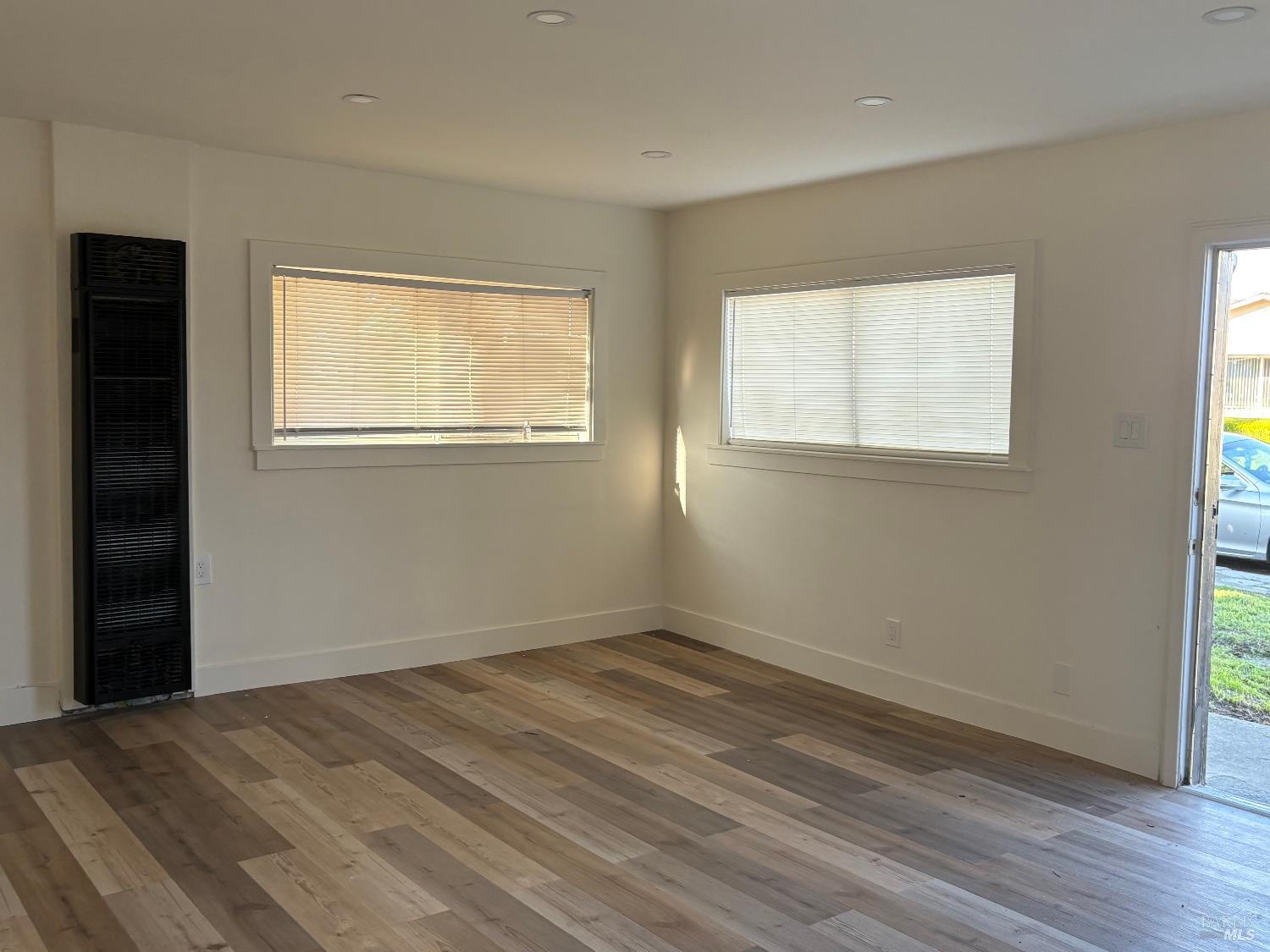 313 Roney Avenue Vallejo, CA 94590 - Photo 8 of 26 a view of an empty room with wooden floor and a window