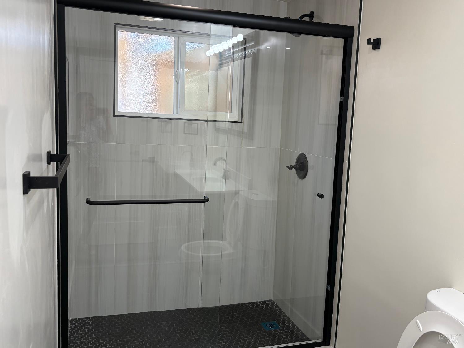 313 Roney Avenue Vallejo, CA 94590 - Photo 10 of 26 a bathroom with a glass shower door