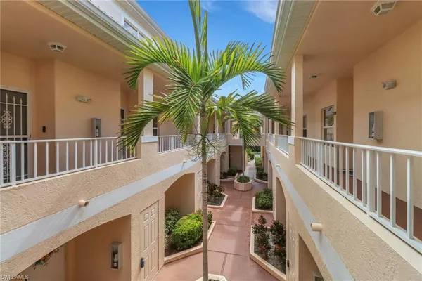 a view of a house with a palm tree