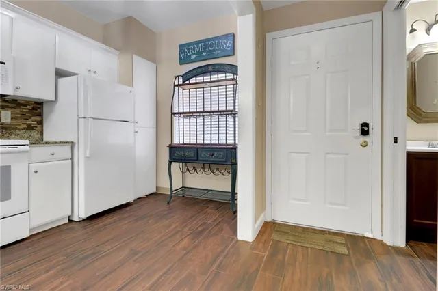 a view of kitchen with wooden floor and electronic appliances