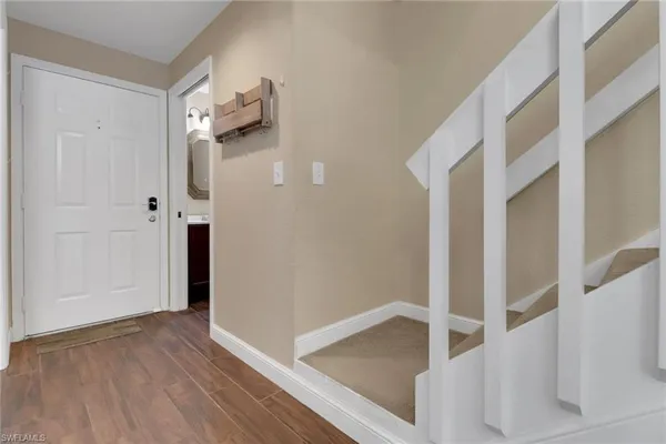 a view of an entryway with wooden floor