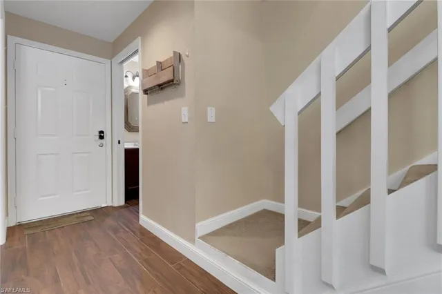 a view of an entryway with wooden floor
