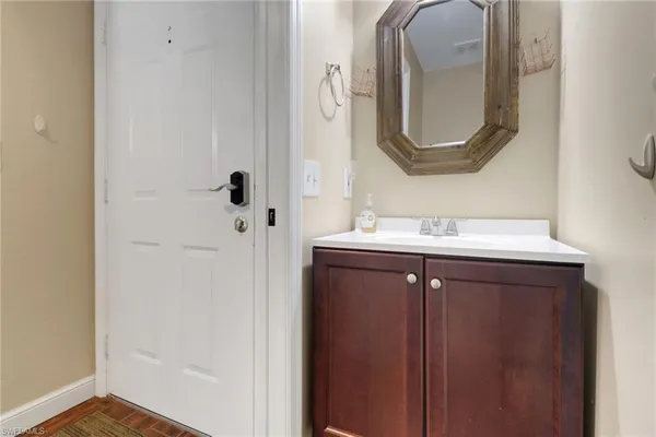 a bathroom with a sink vanity and a mirror