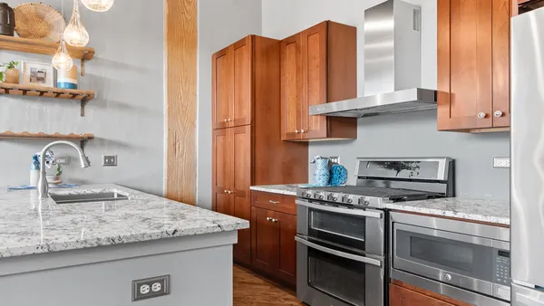 a kitchen with granite countertop a sink and cabinets
