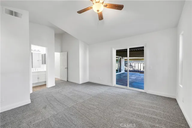 an empty room with closet and windows