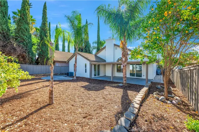 a view of a house with a yard and tree s