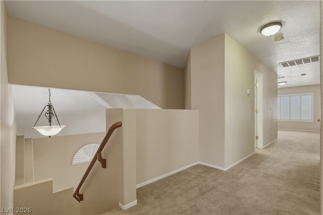 29 Olive Tree Henderson, NV 89074 - Photo 26 of 60 Navigate this bright and airy upper landing, featuring inviting spaces for quiet relaxation or active pursuits.