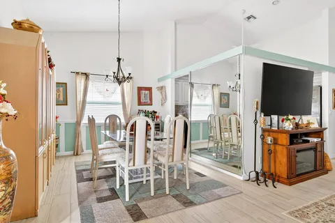 a view of a living room with furniture and floor to ceiling window