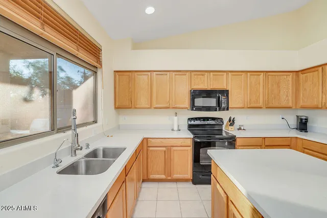a kitchen that has a sink and a stove top oven