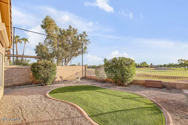 a view of a swimming pool with a yard