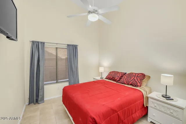 a bedroom with a bed and a lamp