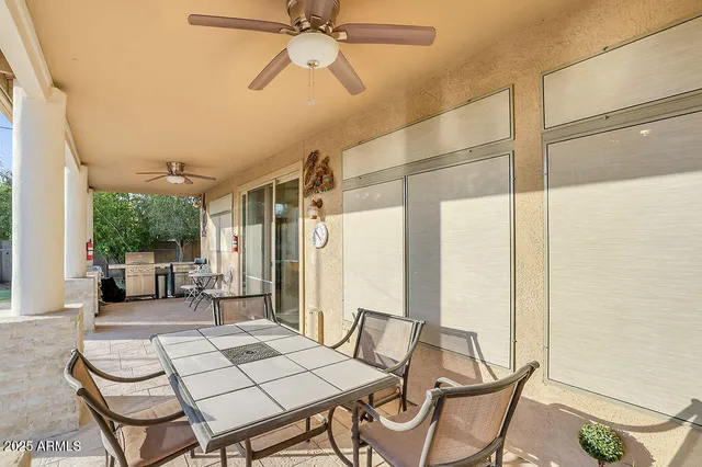 a view of a patio with table and chairs and potted plants