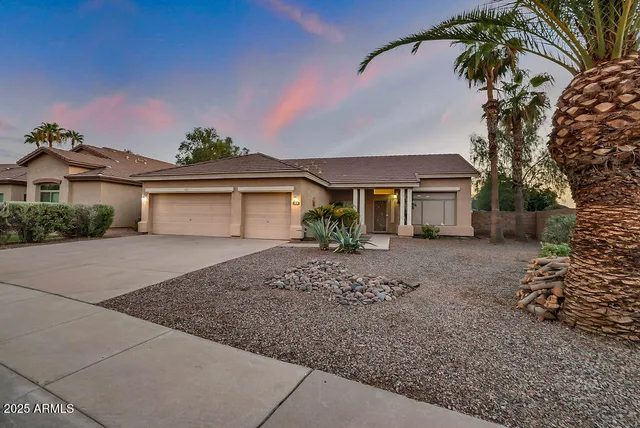 a view of a patio with a table and chairs potted plants