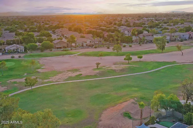 an aerial view of multiple houses with a yard