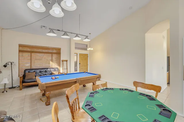 a room with pool table and windows