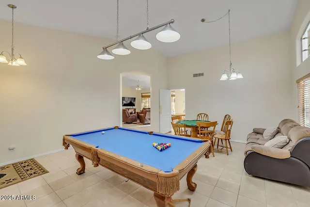 a room with furniture pool table and view view