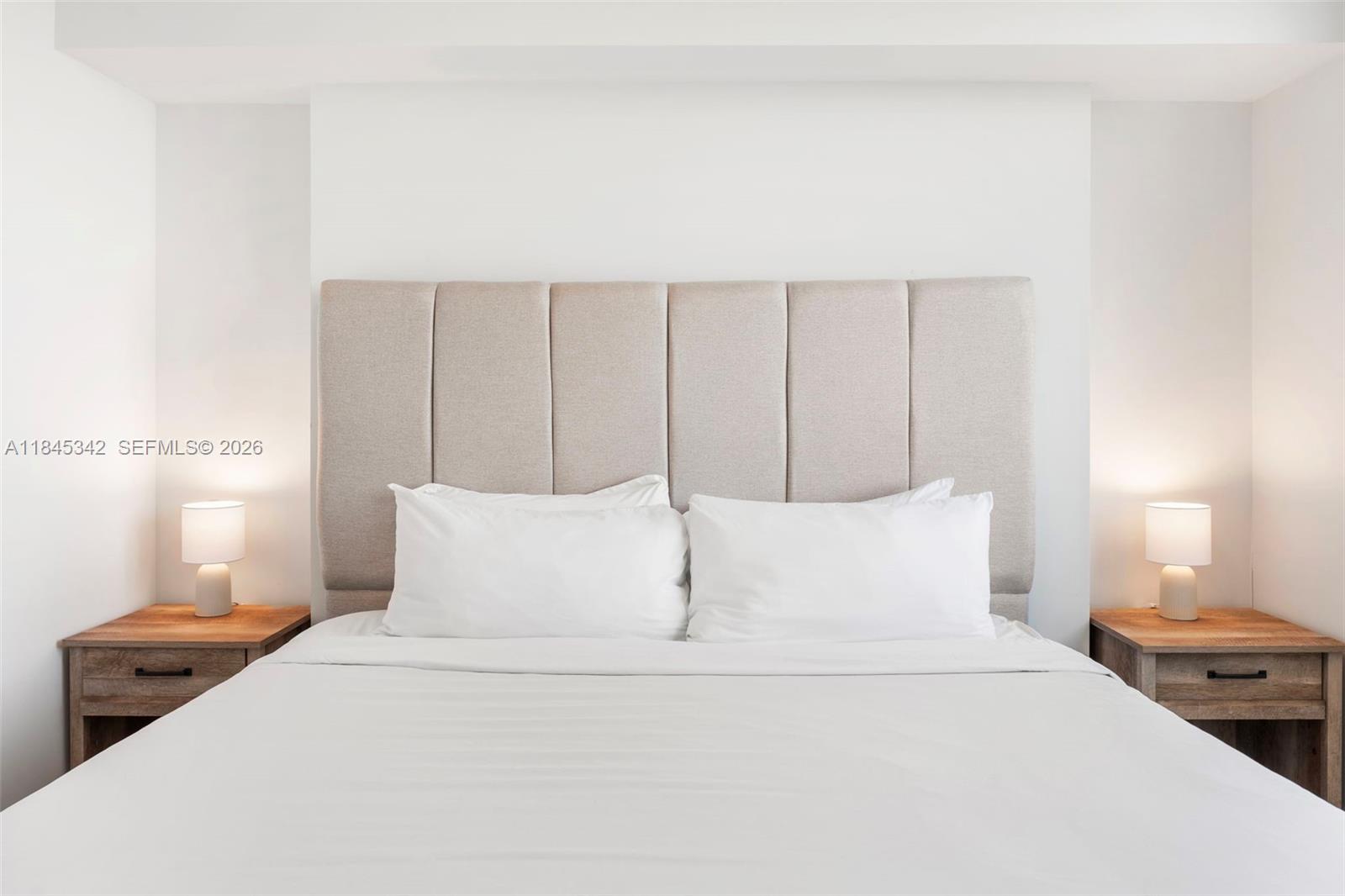 3900 Biscayne Boulevard, Unit S400 Miami, FL 33137 - Photo 15 of 50 a bedroom with a bed and a night stand