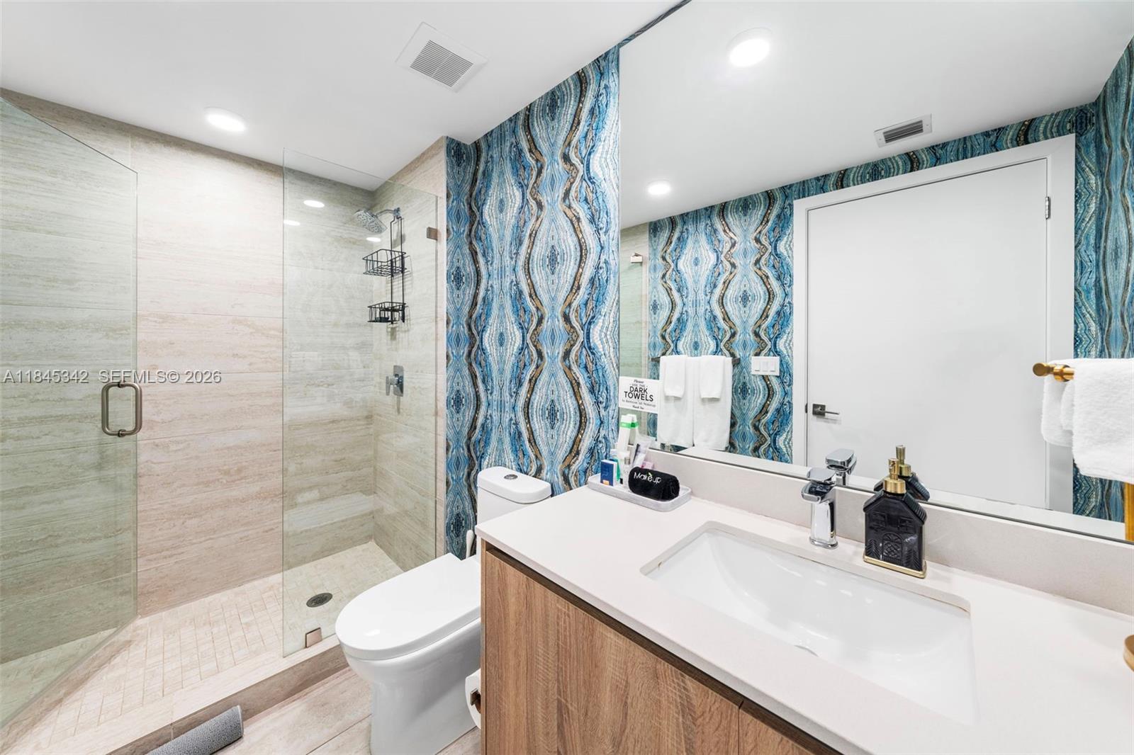 3900 Biscayne Boulevard, Unit S400 Miami, FL 33137 - Photo 18 of 50 a bathroom with a sink a toilet and shower