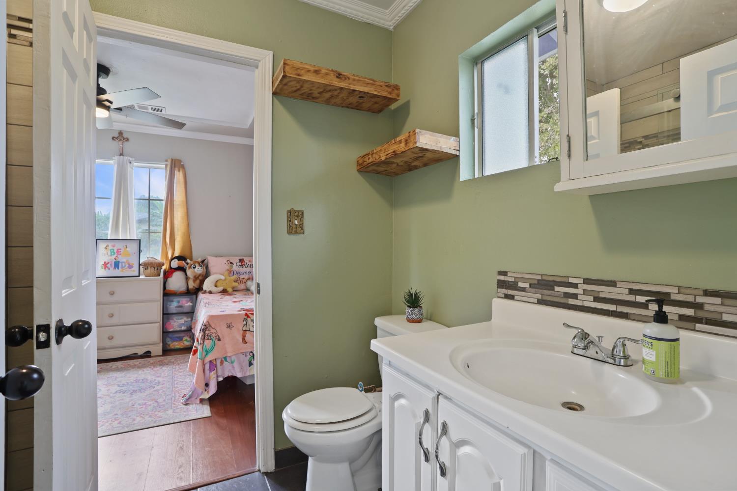 513 Harold Street Lodi, CA 95240 - Photo 14 of 29 a bathroom with a sink toilet and shower