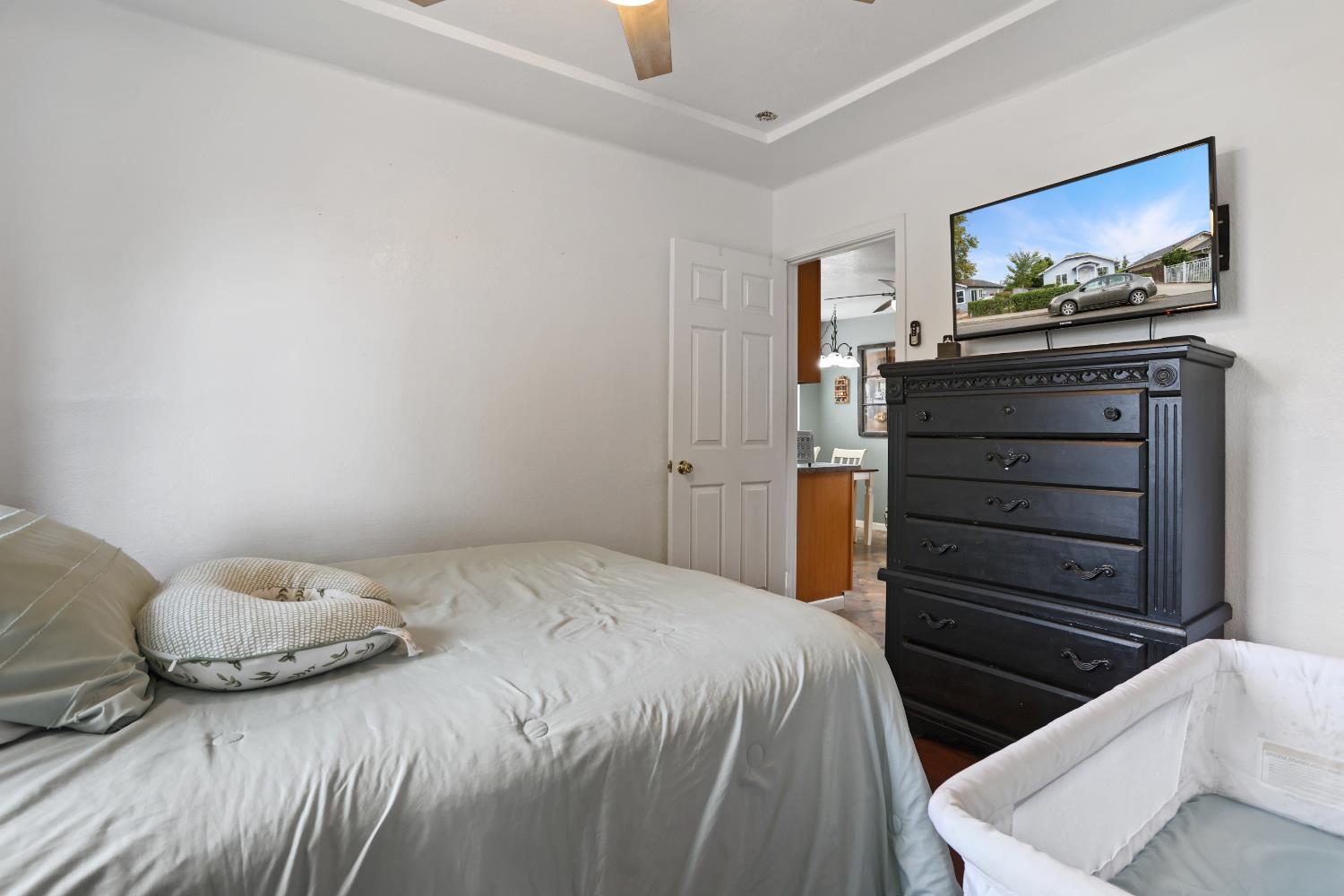513 Harold Street Lodi, CA 95240 - Photo 15 of 29 a bedroom with a bed and a flat screen tv