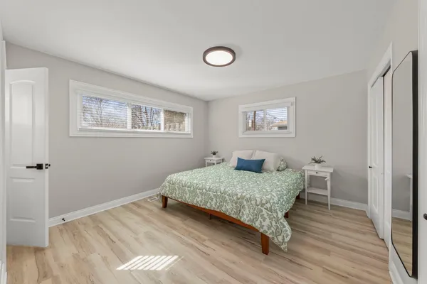 a bedroom with a large bed and a chandelier