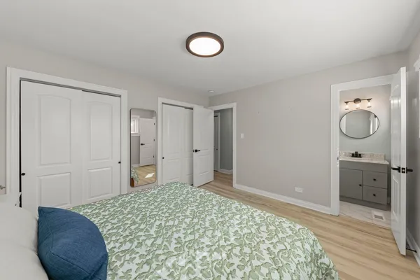 a bedroom with a bed and a chandelier