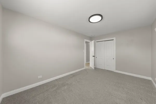 an empty room with windows and closet