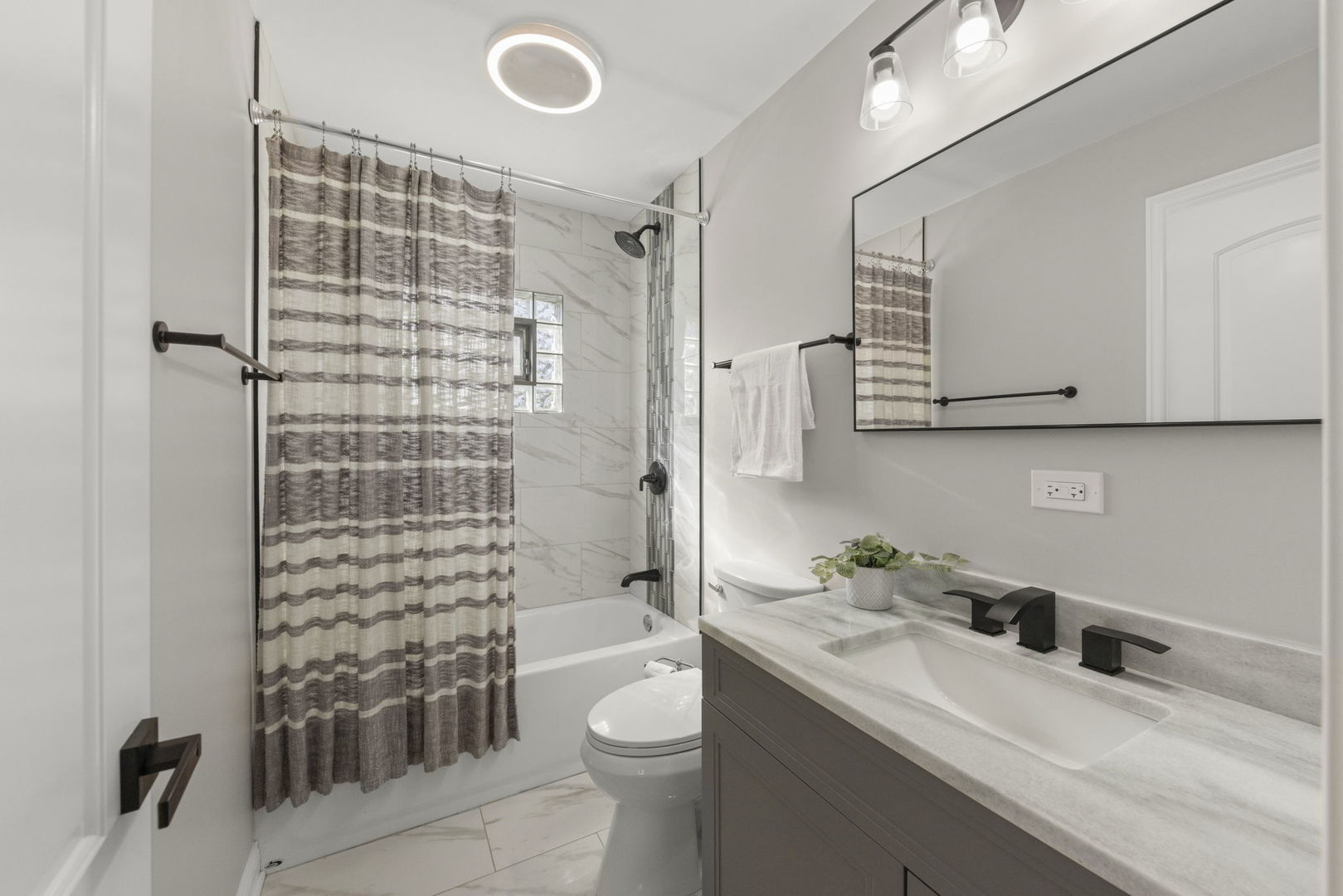 405 Turf Lane Wheaton, IL 60187 - Photo 23 of 29 a bathroom with a sink a toilet and shower