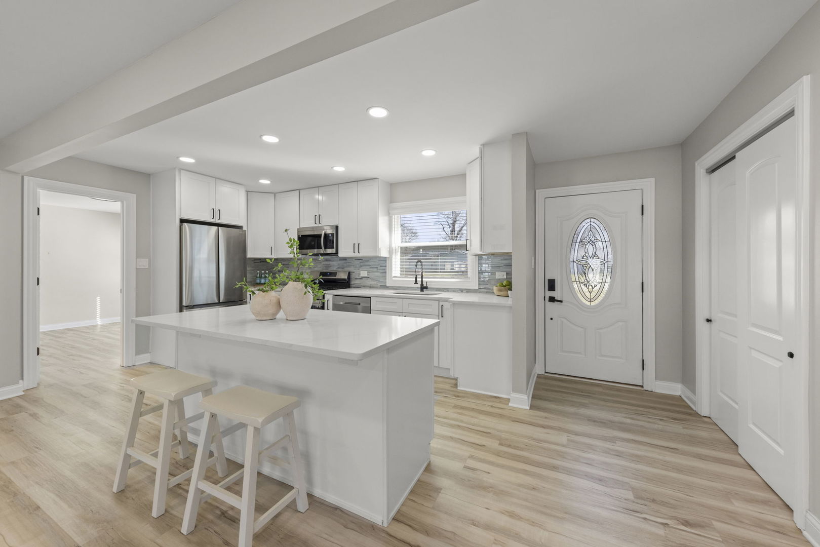 405 Turf Lane Wheaton, IL 60187 - Photo 3 of 29 a kitchen with granite countertop a refrigerator oven a sink dishwasher and white cabinets with wooden floor