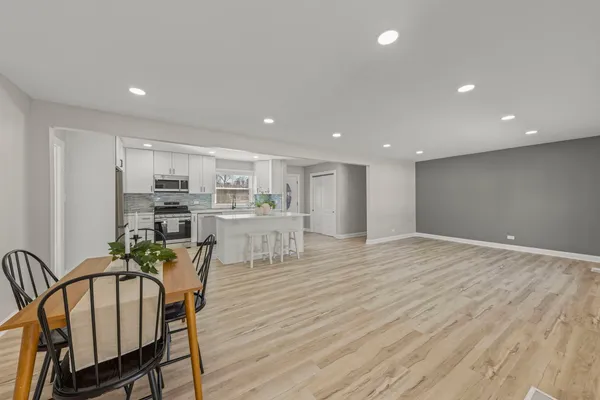 a view of a kitchen with dining table and chairs