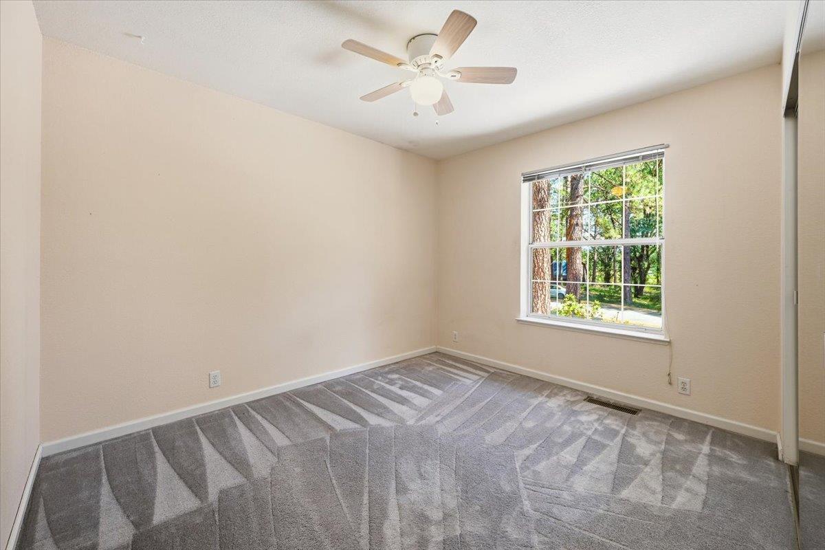 12600 Friar Tuck Road Grass Valley, CA 95949 - Photo 13 of 56 an empty room with a window and a fan