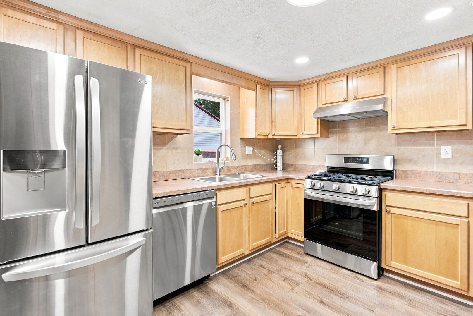 913 Church Road Aurora, IL 60505 - Photo 5 of 31 a kitchen with stainless steel appliances granite countertop a refrigerator stove and sink