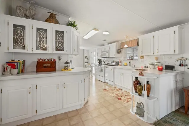 a bedroom with a bed and a lamp on dresser
