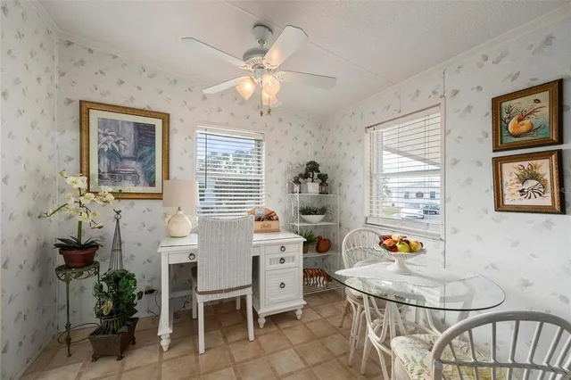 a view of a chair and table in the back yard of the house