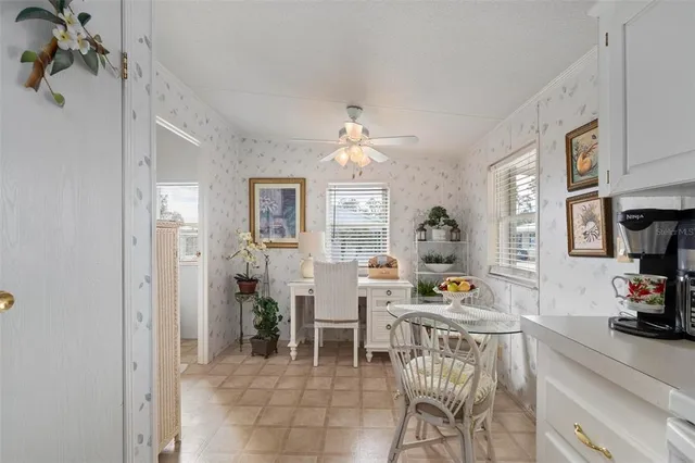 a view of a patio with table and chairs and wooden fence