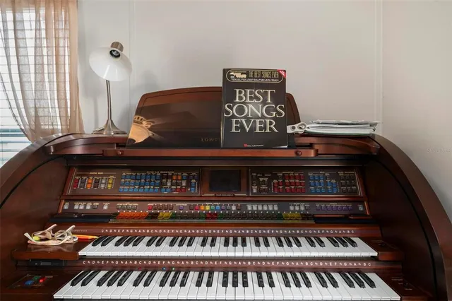 an aerial view of a city with lots of residential buildings ocean and mountain view in back
