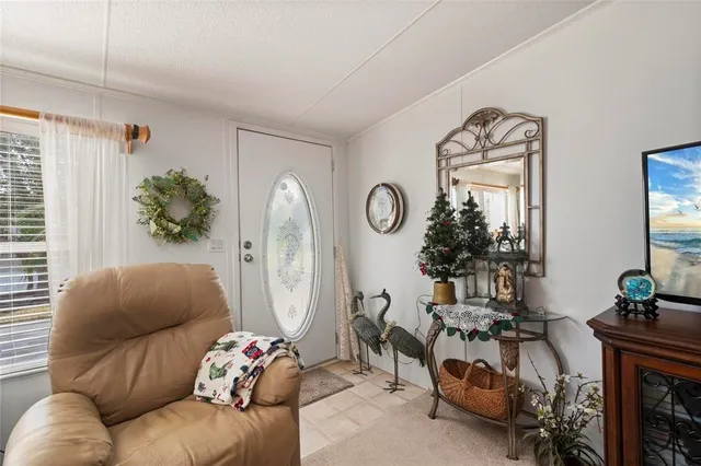 a view of a dining room with furniture and a chandelier