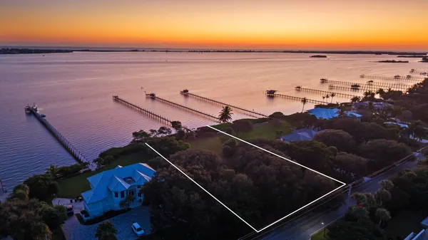 an aerial view of a houses with a yard